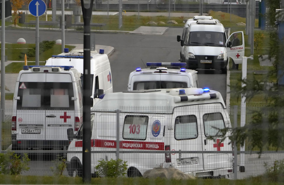 Ambulances stand in line to deliver patients suspected of having coronavirus to a hospital in Kommunarka, outside Moscow, Russia, Tuesday, Oct. 12, 2021. Russia hit another record of daily coronavirus deaths Tuesday as the country struggled with a rapid surge of infections and lagging vaccination rates, but authorities have been adamant that there would be no new national lockdown. (AP Photo/Alexander Zemlianichenko)