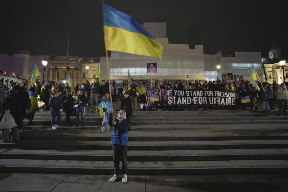 People attend a vigil at the Trafalgar Square organised by the Ukrainian and US Embassy, ahead of the one-year anniversary of the invasion of Ukraine, in London, Thursday, Feb. 23, 2023. (AP Photo/Kin Cheung)