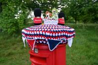 <p>In Hangleton, near Hove in East Sussex, you'll find this post box cover complete with knitted bunting and tiny replicas of the Queen's guards, a little corgi and the Queen herself.</p>