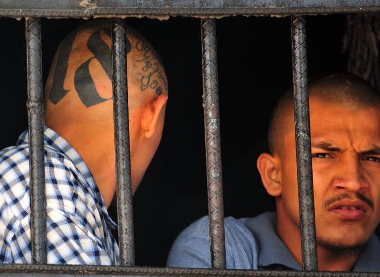 Members of the Mara 18 gang are pictured behind bars at the prison of San Pedro Sula, 240 km north of Tegucigalpa, on May 28, 2013