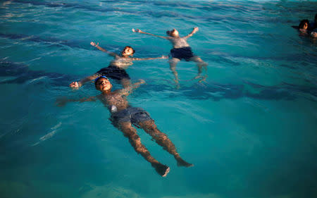 Palestinian boys swim at Sharm Park Water City, in Gaza July 9, 2018. REUTERS/Mohammed Salem