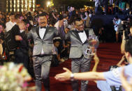 Taiwanese same-sex couples go red carpet at their wedding party in Taipei, Taiwan, Saturday, May 25, 2019. Taiwan became the first place in Asia to allow same-sex marriage last week. Hundreds of same-sex couples in Taiwan rushed to get married Friday, the first day a landmark decision that legalized same-sex marriage took effect. (AP Photo/Chiang Ying-ying)