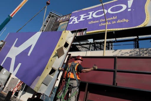 File picture shows a worker moving a section of a Yahoo! billboard onto a truck in San Francisco, California. Yahoo! is dumping products along with workers in a quest to return the faded Internet star to glory