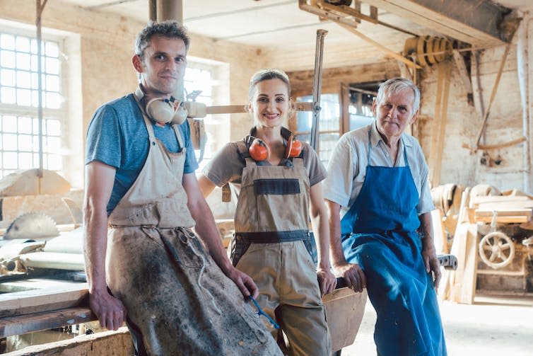 Carpenter family business with generations in the workshop having a break