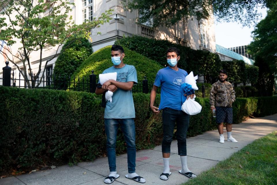 <div class="inline-image__caption"><p>Migrants from Venezuela, who boarded a bus in Texas, outside the residence of US Vice President Kamala Harris, at the Naval Observatory in Washington, DC, on Thursday. </p></div> <div class="inline-image__credit">STEFANI REYNOLDS</div>