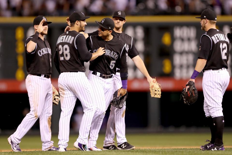 Trevor Story #28, Nolan Arenado #28, Carlos Gonzalez #5 and D.J. LeMahieu #9 of the Colorado Rockies celebrate their win against the Arizona Diamondbacks at Coors Field on June 20, 2017 in Denver, Colorado.