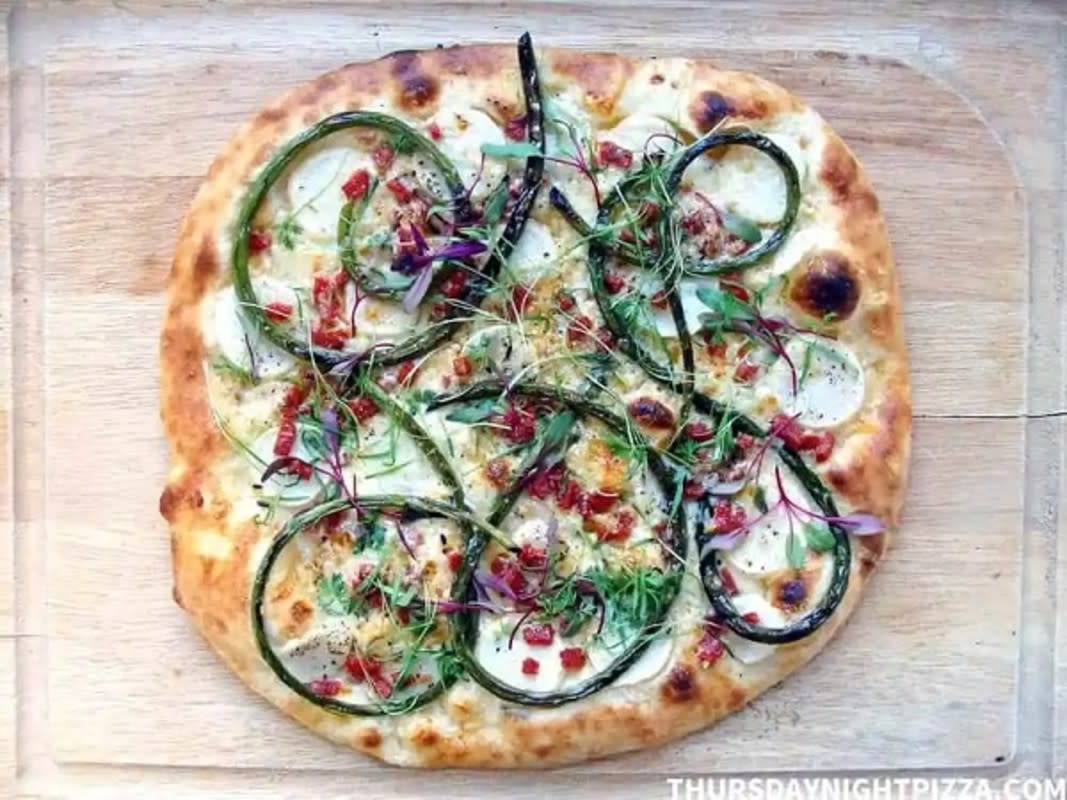 <p>Thursday Night Pizza</p><p><strong>Get the recipe: <a href="https://www.thursdaynightpizza.com/garlic-scape-pizza/" rel="nofollow noopener" target="_blank" data-ylk="slk:Garlic Scape Pizza with Hakurei Turnips and Pepperoni;elm:context_link;itc:0;sec:content-canvas" class="link rapid-noclick-resp">Garlic Scape Pizza with Hakurei Turnips and Pepperoni</a></strong></p>