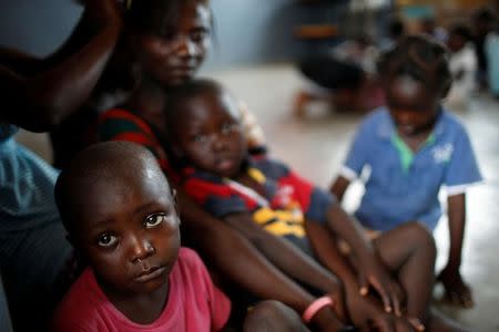 Children sit at a shelter after Hurricane Matthew passes in Jeremie, Haiti, October 9, 2016. REUTERS/Carlos Garcia Rawlins