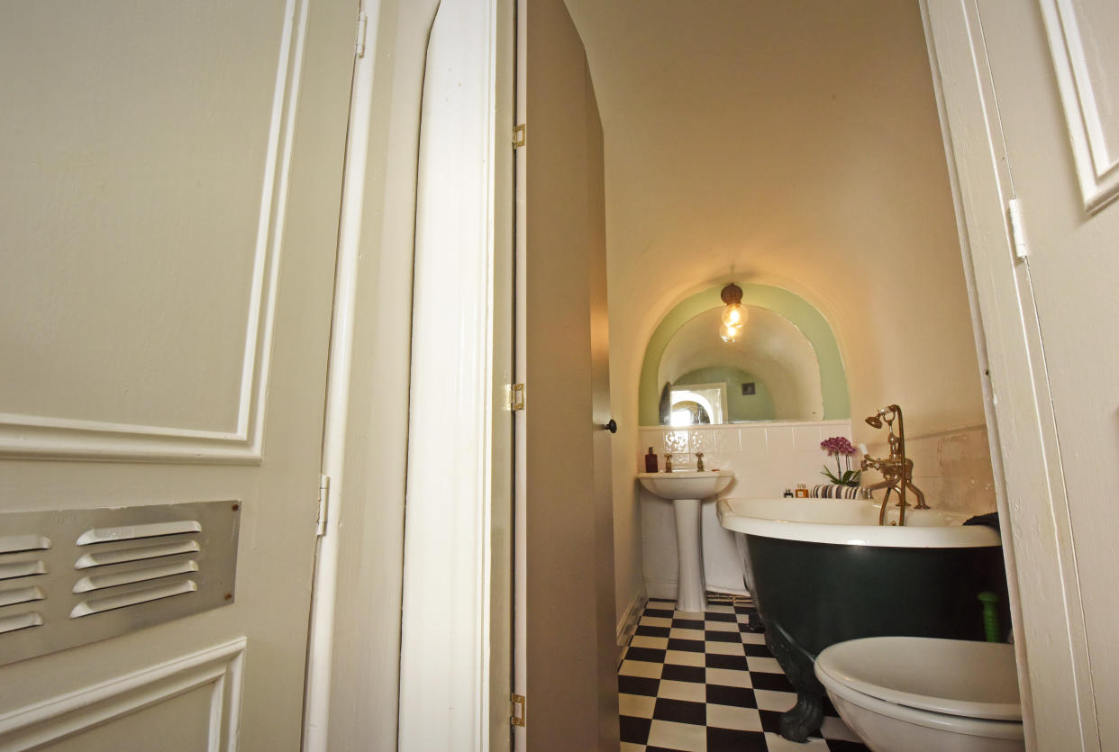 The dreamy bathroom features a roll top bath and is built in an archway dug underground where the driveway is. (William Lailey/Caters)