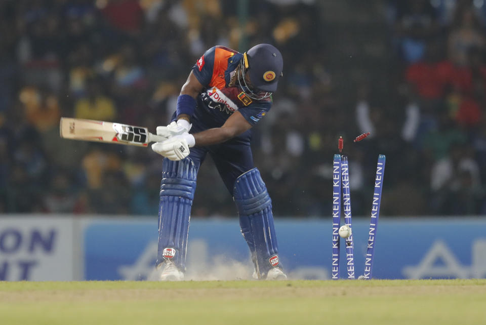 Sri Lanka's Kusal Perera is bowled by West Indies' Andre Russell during their first Twenty20 cricket match in Pallekele, Sri Lanka, Wednesday, March 4, 2020. (AP Photo/Eranga Jayawardena)