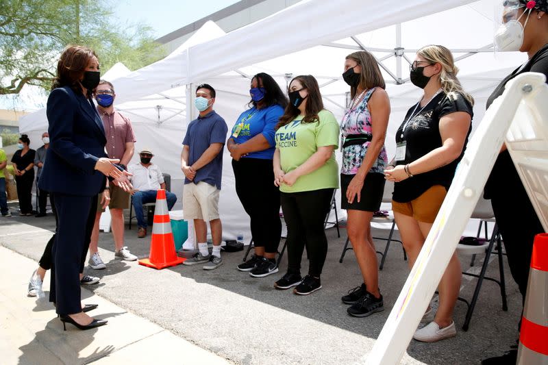 FILE PHOTO: U.S. Vice President Kamala Harris (L) speaks with workers at a pop-up COVID-19 vaccine clinic outside the Carpenters International Training Center in Las Vegas
