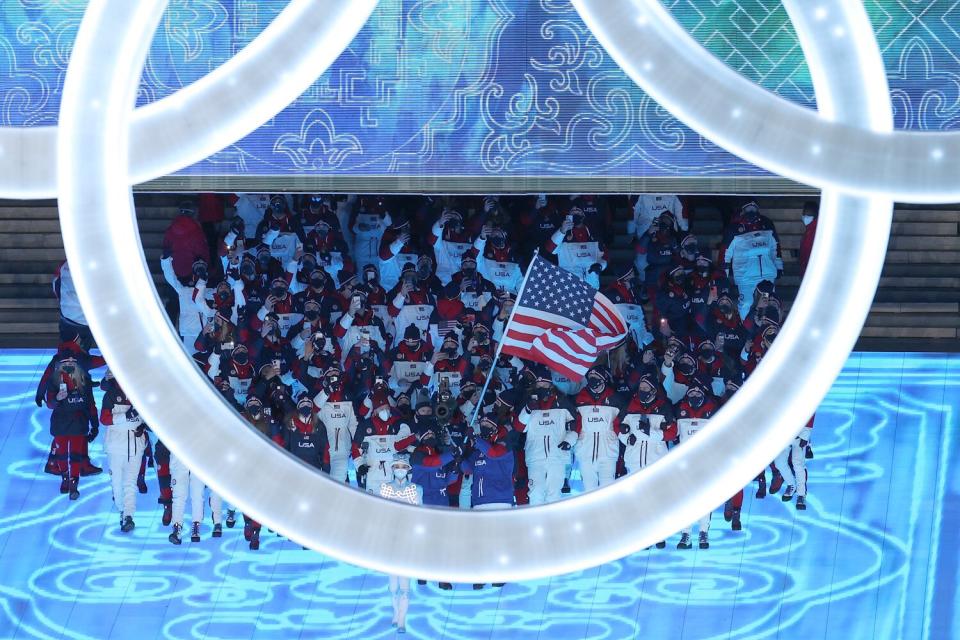 Brittany Bowe and John Shuster of Team United States carry their flag during the Opening Ceremony of the Beijing 2022 Winter Olympics