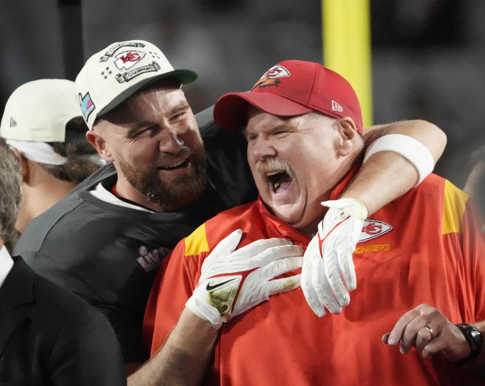 Chiefs head coach Andy Reid celebrates with tight end Travis Kelce on Sunday night.