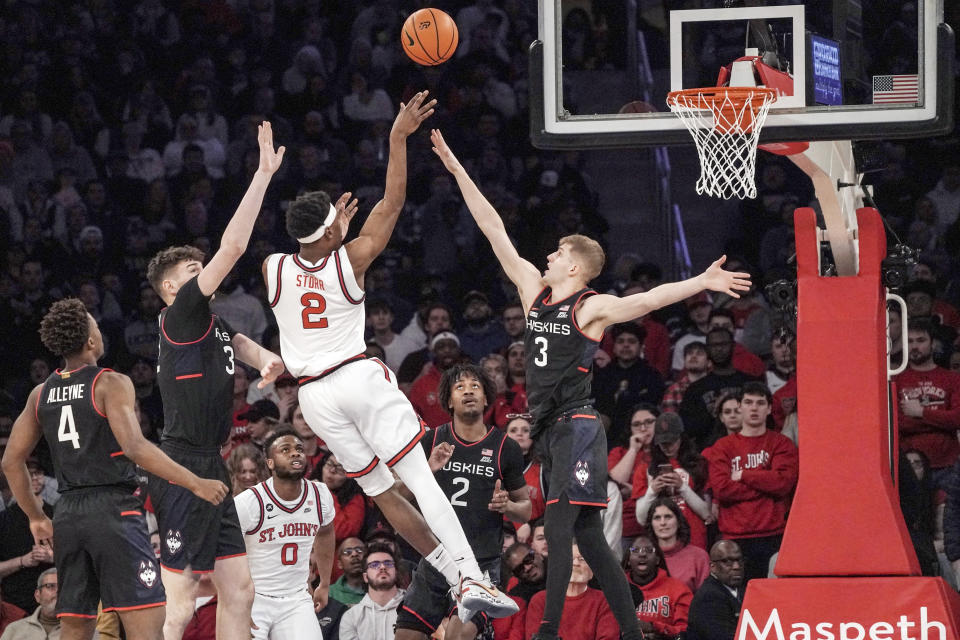 St. John's guard AJ Storr, center, shoots during the first half of an NCAA college basketball game against UConn, Saturday, Feb. 25, 2023, in New York. (AP Photo/Bebeto Matthews)