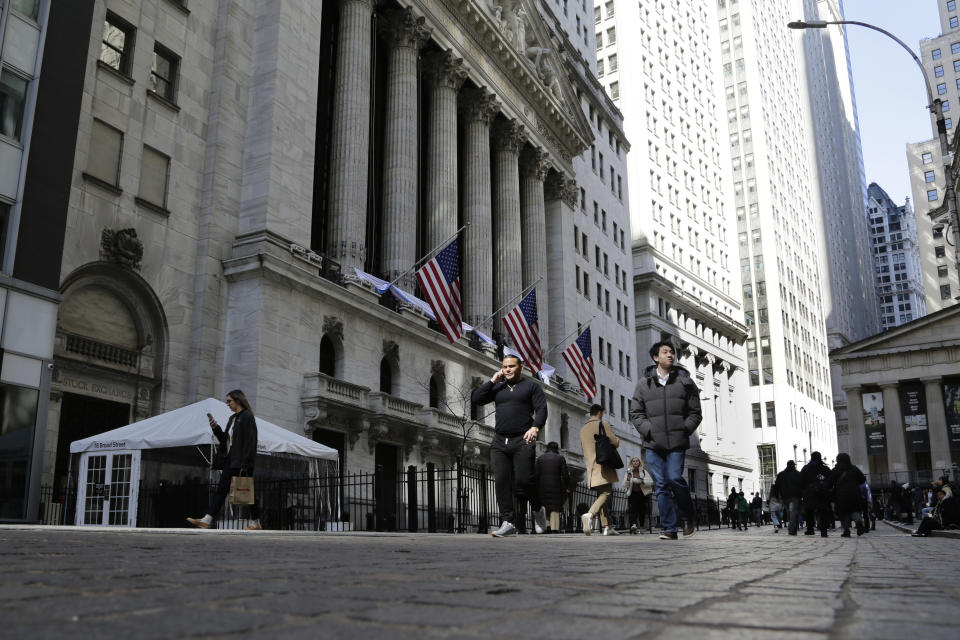 FILE - People pass the front of the New York Stock Exchange in New York, March 21, 2023. The yield on the 10-year Treasury has reached 5%. It's the first time since 2007 that the centerpiece of the global financial system has been that high, with impacts far beyond Wall Street. Treasury yields have been climbing rapidly, with the 10-year yield rallying from less than 3.50% during the spring and from just 0.50% early in the pandemic. (AP Photo/Peter Morgan, File)