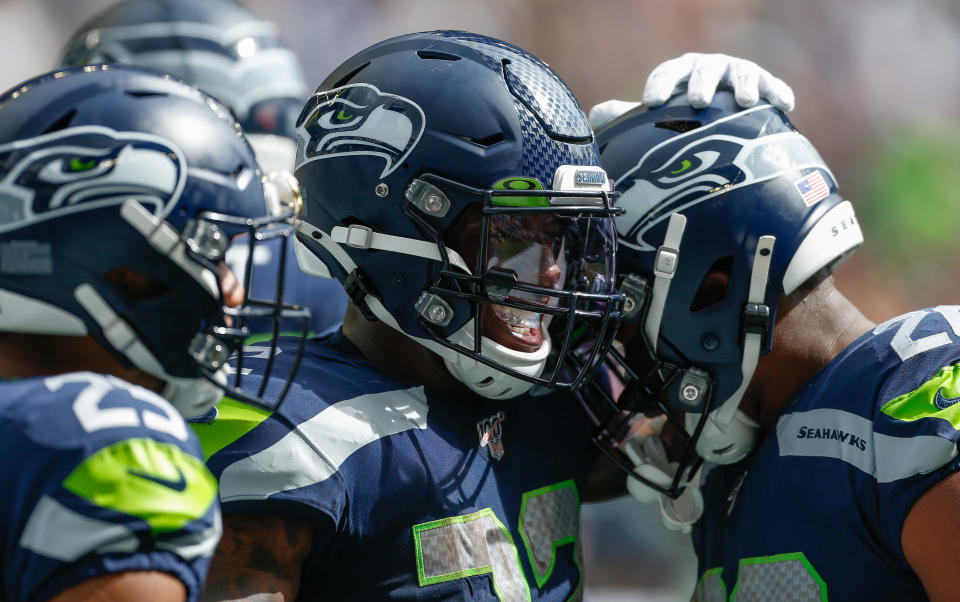 Running back Chris Carson #32 (middle) of the Seattle Seahawks celebrates after scoring a touchdown against the Cincinnati Bengals at CenturyLink Field on September 8, 2019 in Seattle, Washington. (Photo by Otto Greule Jr/Getty Images)