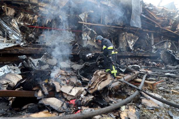 A Ukrainian rescuer works outside a supermarket destroyed as a result of night strike in Odesa on 14 August 2023 (AFP via Getty Images)