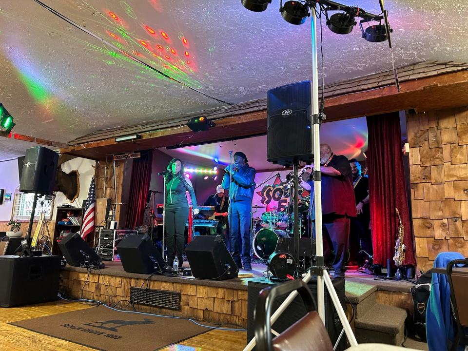 Fred Booker, center, sings with the band Soul Express during a show in Beech Grove.