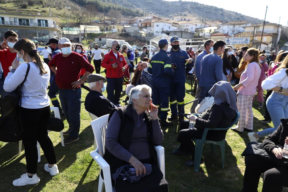 Local residents gather at a soccer field after an earthquake in Damasi village, central Greece, Wednesday, March 3, 2021. An earthquake with a preliminary magnitude of up to 6.3 struck central Greece on Wednesday and was felt as far away as the capitals of neighboring Albania, North Macedonia, Kosovo and Montenegro. (AP Photo/Vaggelis Kousioras)