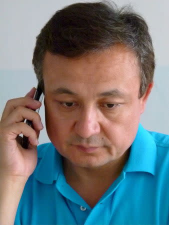 Dolkun Isa, executive chairman of the World Uyghur Congress, speaks on his phone at the organization's Munich office July 6, 2015. REUTERS/David Lague