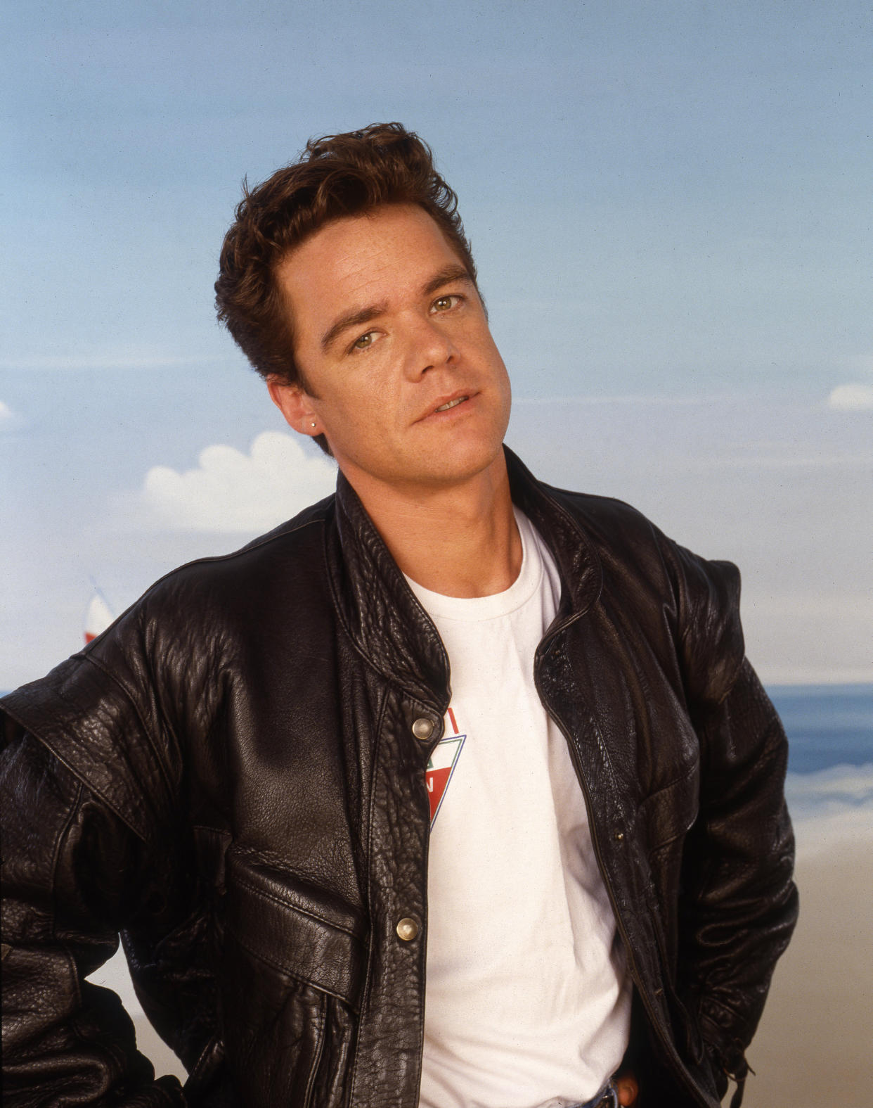 Studio portrait of actor and singer Stefan Dennis, then playing the character of Paul Robinson in Australian TV soap opera 'Neighbours', United Kingdom, circa 1988. (Photo by Tim Roney/Getty Images)