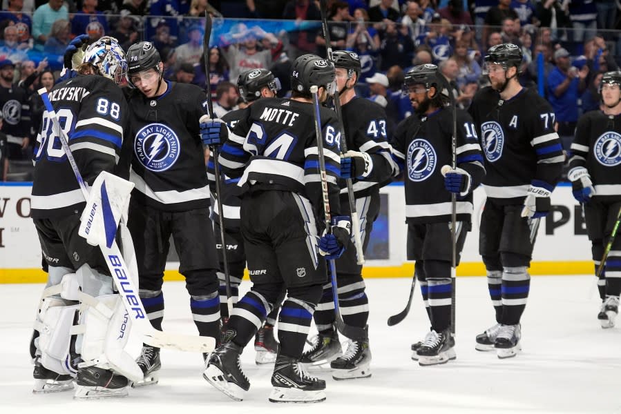 Tampa Bay Lightning goaltender Andrei Vasilevskiy (88) celebrates with teammates after the team defeated the <a class="link " href="https://sports.yahoo.com/nhl/teams/ny-islanders/" data-i13n="sec:content-canvas;subsec:anchor_text;elm:context_link" data-ylk="slk:New York Islanders;sec:content-canvas;subsec:anchor_text;elm:context_link;itc:0">New York Islanders</a> during an NHL hockey game Saturday, March 30, 2024, in <a class="link " href="https://sports.yahoo.com/nhl/teams/tampa-bay/" data-i13n="sec:content-canvas;subsec:anchor_text;elm:context_link" data-ylk="slk:Tampa;sec:content-canvas;subsec:anchor_text;elm:context_link;itc:0">Tampa</a>, Fla. (AP Photo/Chris O’Meara)