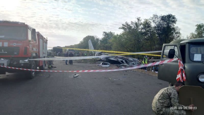 Investigators work at a crash site of the Ukrainian military Antonov An-26 aircraft outside Chuhuiv
