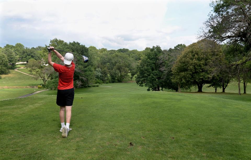 Griffin Moore, 15, of Springfield tees off on the 8th hole at Pasfield Golf Course on Friday, July 8, 2022.