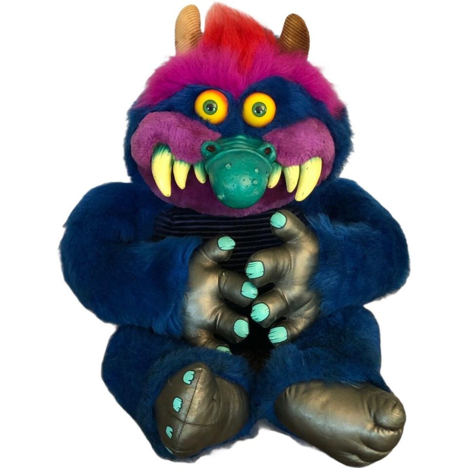 A cute-ish blue and purple monster with a big teal plastic nose