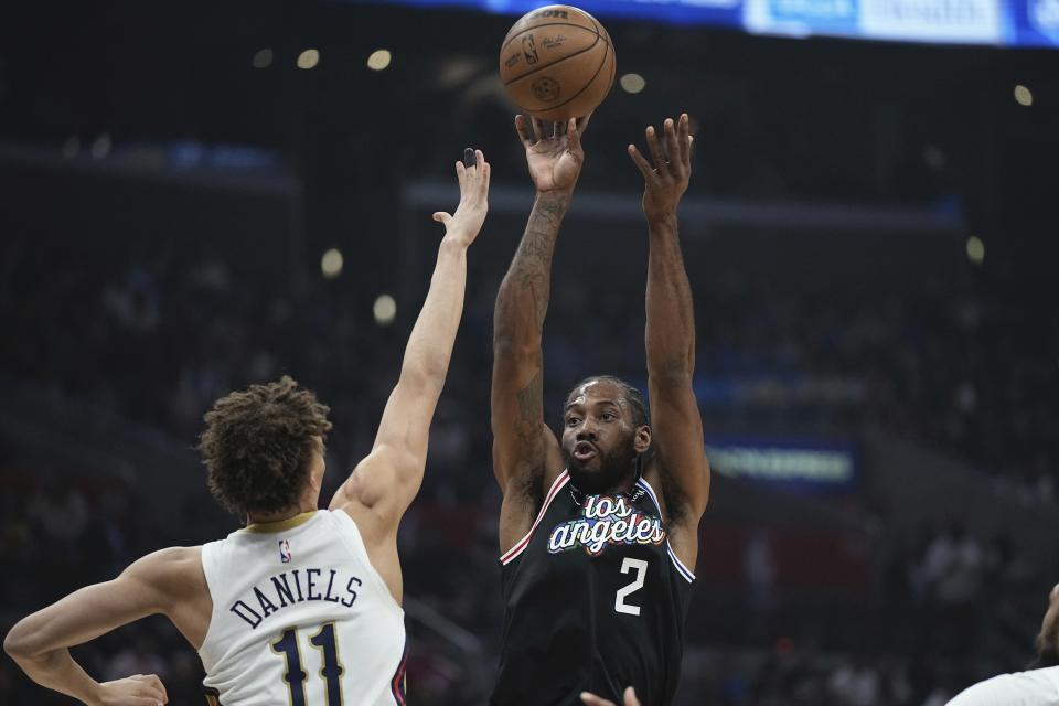 Los Angeles Clippers forward Kawhi Leonard, right, shoots as New Orleans Pelicans guard Dyson Daniels defends during the first half of an NBA basketball game Saturday, March 25, 2023, in Los Angeles. (AP Photo/Mark J. Terrill)