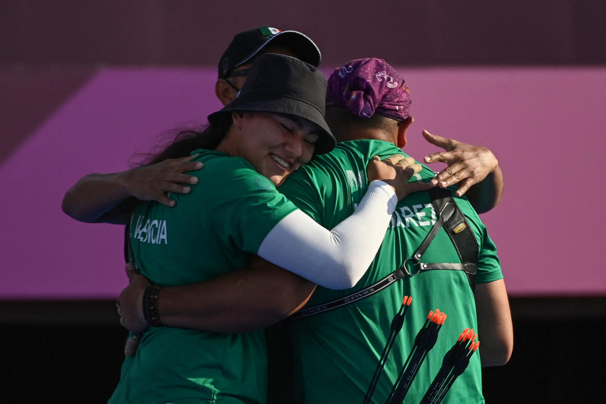 Mexico's Alejandra Valencia (C) and Luis Alvarez (R) celebrate their victory against Turkey in the mixed team bronze medal match during the Tokyo 2020 Olympic Games at Yumenoshima Park Archery Field in Tokyo on July 24, 2021. (Photo by ADEK BERRY / AFP) (Photo by ADEK BERRY/AFP via Getty Images)