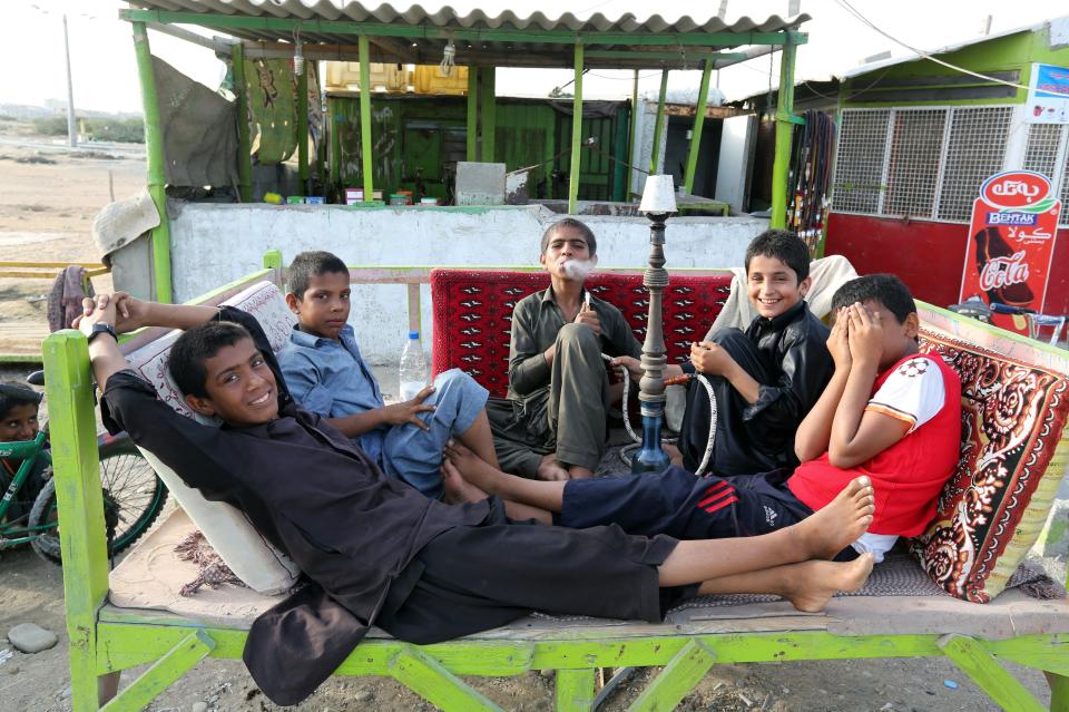 Youths smoke a water pipe in Chabahar, Iran, on May 12, 2015.