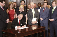 South Carolina Gov. Henry McMaster ceremonially signs a bill allowing early voting in the state on Wednesday, May 18, 2022, in Columbia, S.C. (AP Photo/Jeffrey Collins)