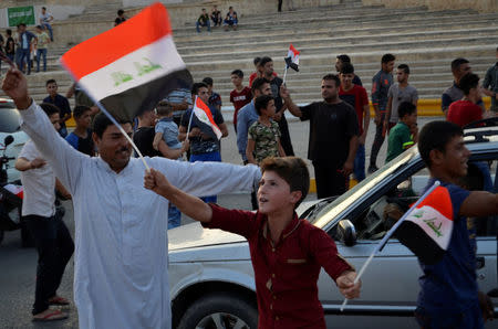 Iraqi people celebrate the liberation of the embattled city of Mosul, in Mosul, Iraq July 9, 2017. REUTERS/Stringer