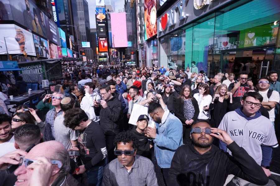 People view a solar eclipse in Times Square, Monday, April 8, 2024, in New York. (AP Photo/Peter K. Afriyie)
