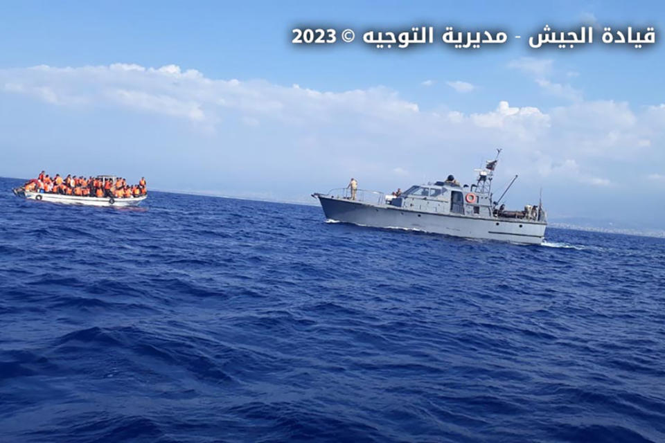 In this photo released by the Lebanese Army official website, a Lebanese vessel approaches a overcrowded boat with migrants in the Mediterranean Sea, near the shores of Tripoli, north Lebanon, Friday, Oct. 6, 2023. Lebanon's state-run National News Agency says the army has rescued more than 100 migrants after their boat faced technical problems in the Mediterranean Sea. The agency says the boat called for help after it ran into difficulties Friday afternoon in Lebanese territorial waters. (Lebanese Army Website via AP)