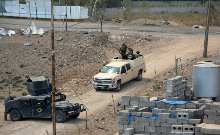 Iraqi government forces and the elite counter-terrorism service (CTS) members drive through the northern town of Qayyarah on August 24, 2016, after they took key positions in the centre from Islamic State (IS) group jihadists