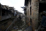 Damaged houses are pictured as a man walks along deserted street after the earthquake in Bhaktapur, Nepal April 27, 2015. REUTERS/Navesh Chitrakar