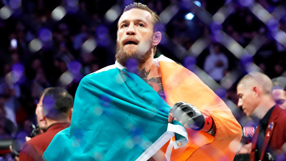 Conor McGregor (pictured) holds the Irish flag after a fight.