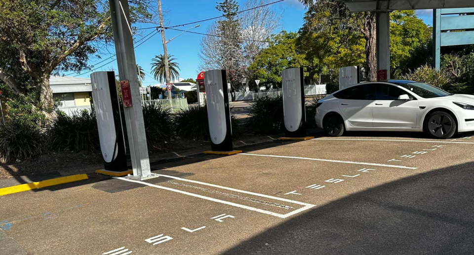 Empty Tesla charging bays at a NSW service station, as EV driver says infrastructure is adequate.
