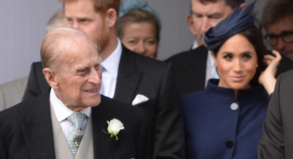 Prince  Philip with Prince Harry and Duchess Meghan sitting behind him