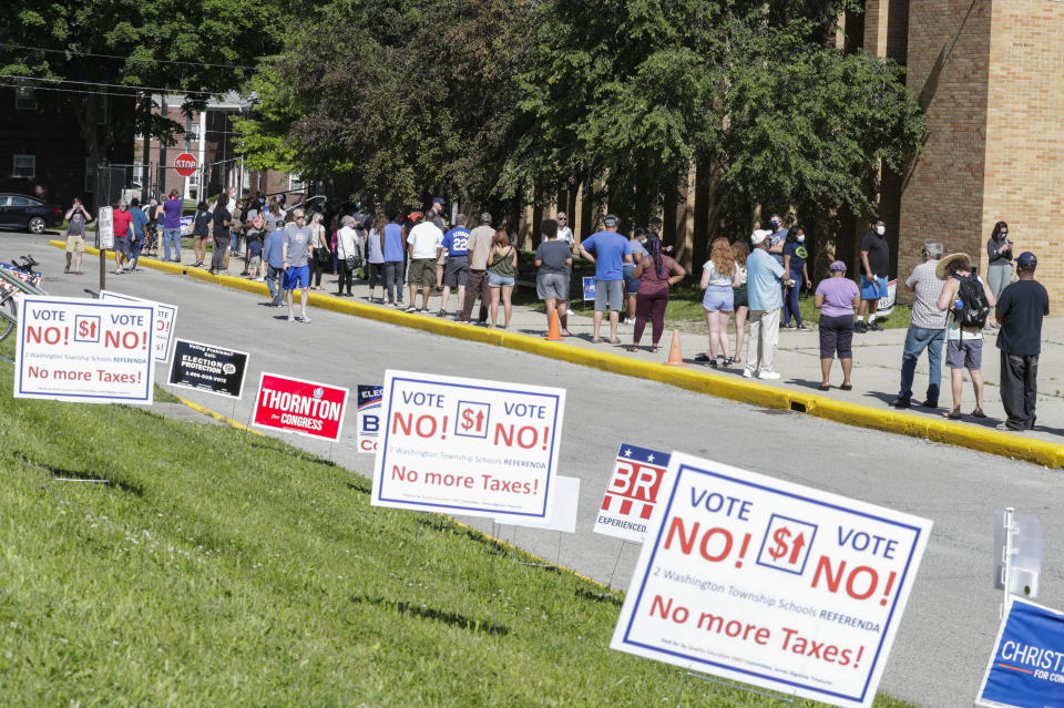 Voters wait in a line outside Broad Ripple High School to vote in the Indiana primary in Indianapolis on June 2, 2020. (Michael Conroy/AP)