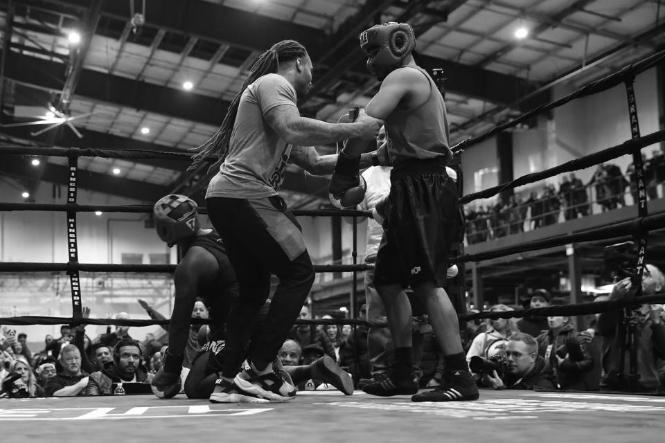 <p>New York City Police officer Anthony Davilla of the 79th precinct is pulled away by the referee after knocking down EMS officer Kwane Mendez at the “Bronx Tough Turkey Tussle” in the Hunts Point section of the Bronx, New York, on Nov. 16, 2017. (Photo: Gordon Donovan/Yahoo News) </p>