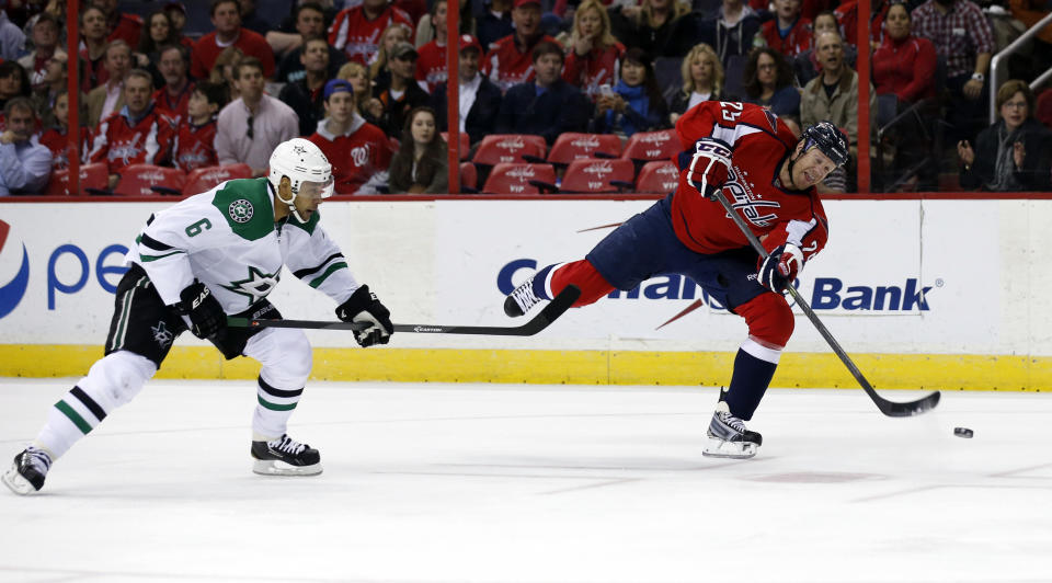 Washington Capitals left wing Jason Chimera (25) shoots as he guarded by Dallas Stars defenseman Trevor Daley (6) in the first period of an NHL hockey game, Tuesday, April 1, 2014, in Washington. (AP Photo/Alex Brandon)