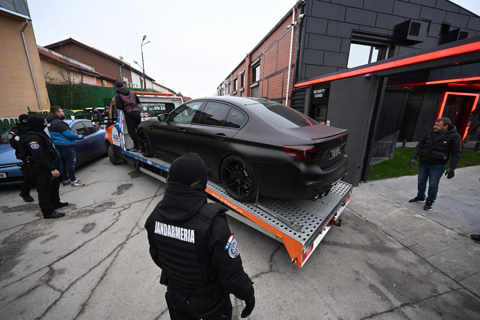 Police transport a Luxury car on a platform out from the site of "The Hustlers University" belonging to controversial influencer Andrew Tate and his brother in Bucharest on January 14, 2022.
