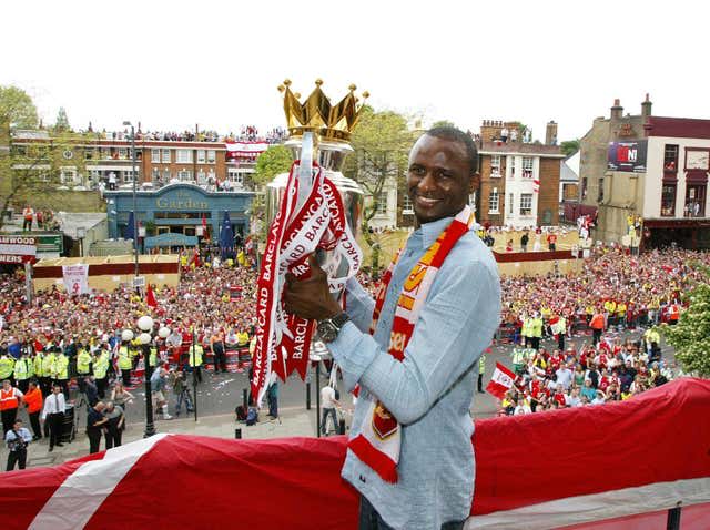 Former Arsenal captain Patrick Vieira holds up the Premier League trophy