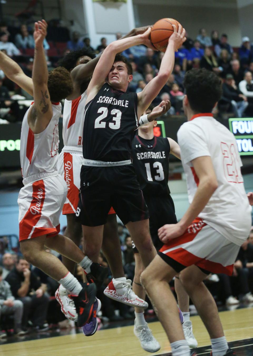 Scarsdale's Asher Krohn (23) is surrounded by North Rockland defenders as he tries to get off a shot during the boys Section 1 Class AA championship at the Westchester County Center in White Plains March 5, 2023. North Rockland won the game 52-40