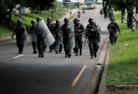 Members of the military police prepare to remove barricades during a protest against the government of Honduras' President Juan Orlando Hernandez, in Tegucigalpa