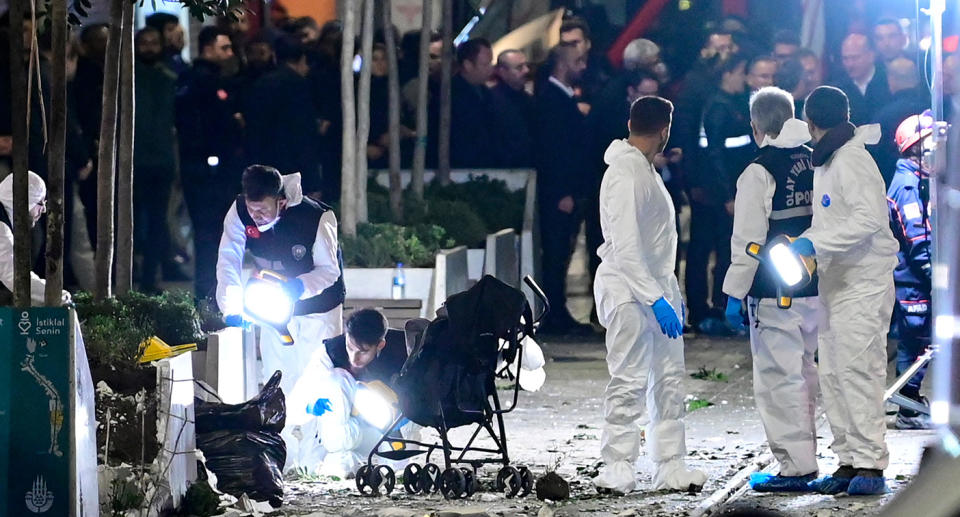Members of a forensic team work after a strong explosion shook the busy shopping street of Istiklal in Istanbul.