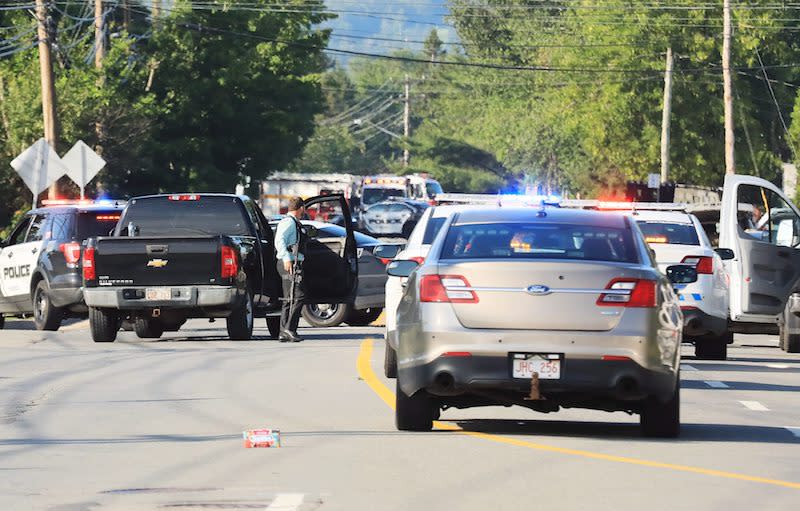 Police officers survey the area of a shooting in Fredericton, N.B., on August 10, 2018, which left four people dead. Photo from The Canadian Press.